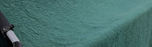 Finished teal wholecloth quilt made from an upcycled scorched cashmere duvet cover, quilted on the Bernina Q24 longarm