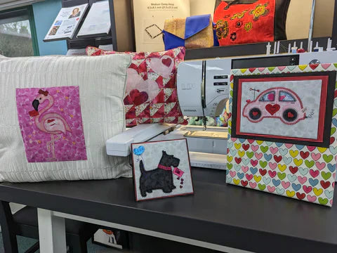 Valentine's Day projects made with AccuQuilt appliqué dies including a love bug card and heart cushion