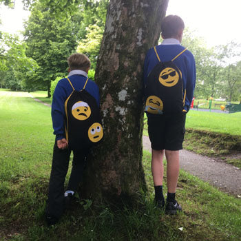 Finished emoji appliqué drawstring kit bags made with AccuQuilt GO!