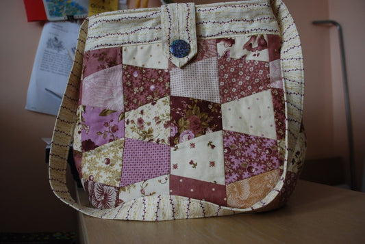 Finished tumbler bag made from a layer cake using the AccuQuilt GO! Multiple Tumbler 3½" die