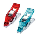 Two mini wonder clips, one red and one blue, on a white background