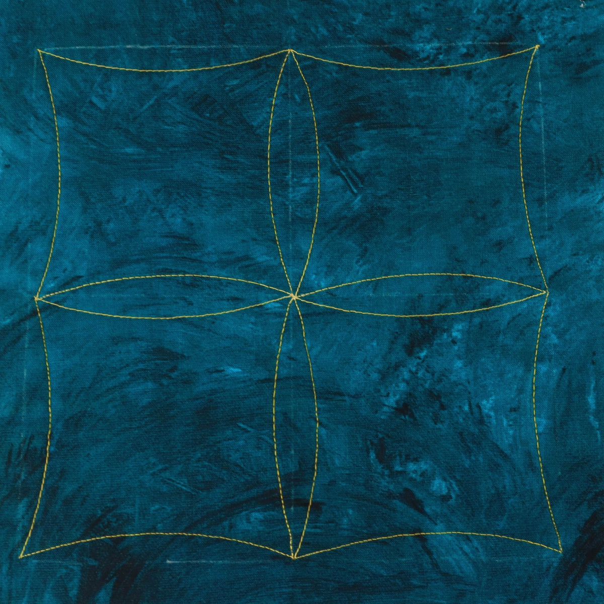 Teal fabric quilting sample with gold stitching forming four curved squares and overlapping petal shapes