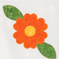 AccuQuilt GO! Round Flower shape in orange with a yellow centre and two green leaves