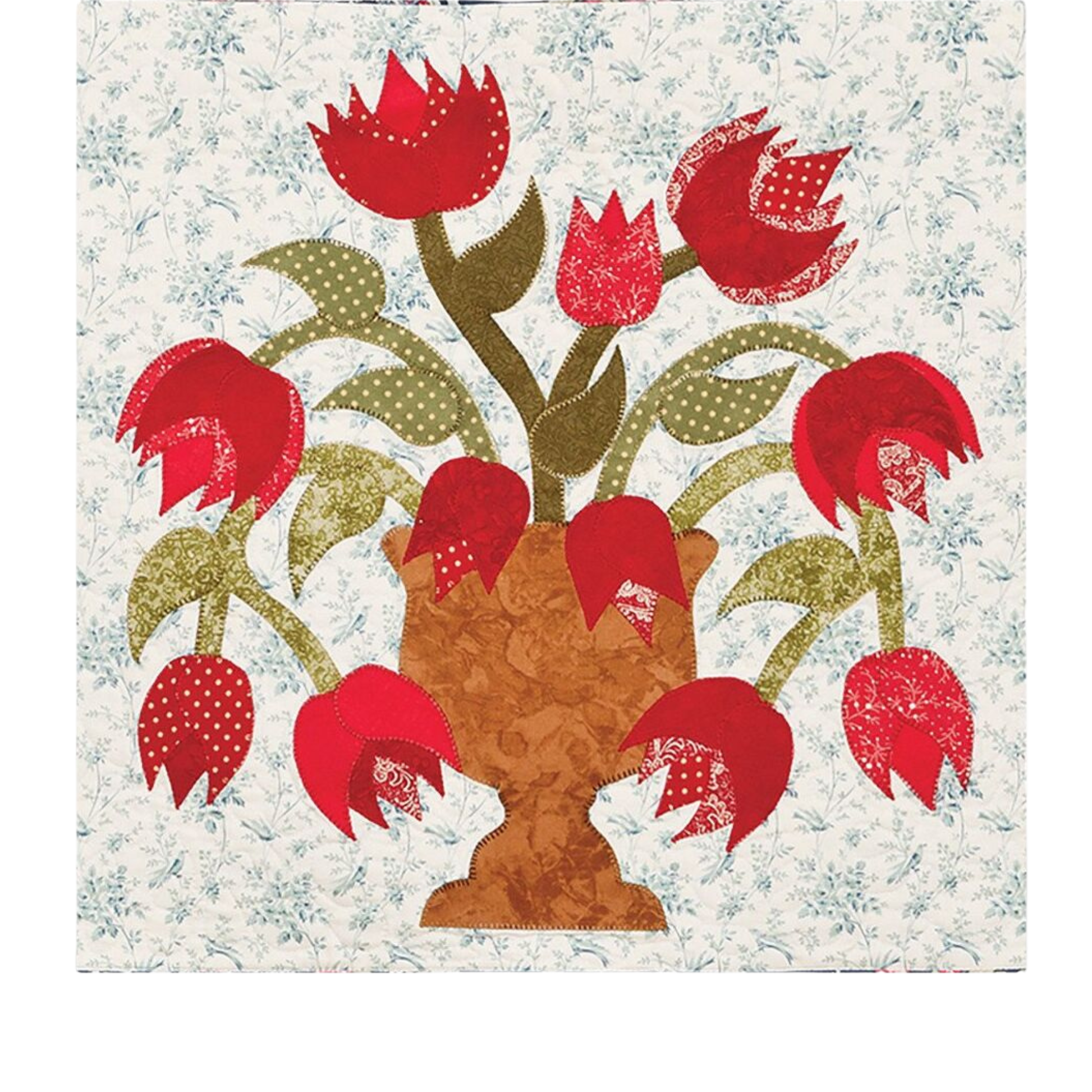 AccuQuilt GO! Feathers shapes forming red tulip petals and leaves in a brown vase on a quilt block