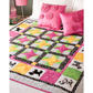 AccuQuilt GO! Gingham Dog quilt with pink star blocks and dog silhouette borders, styled with pink cushions