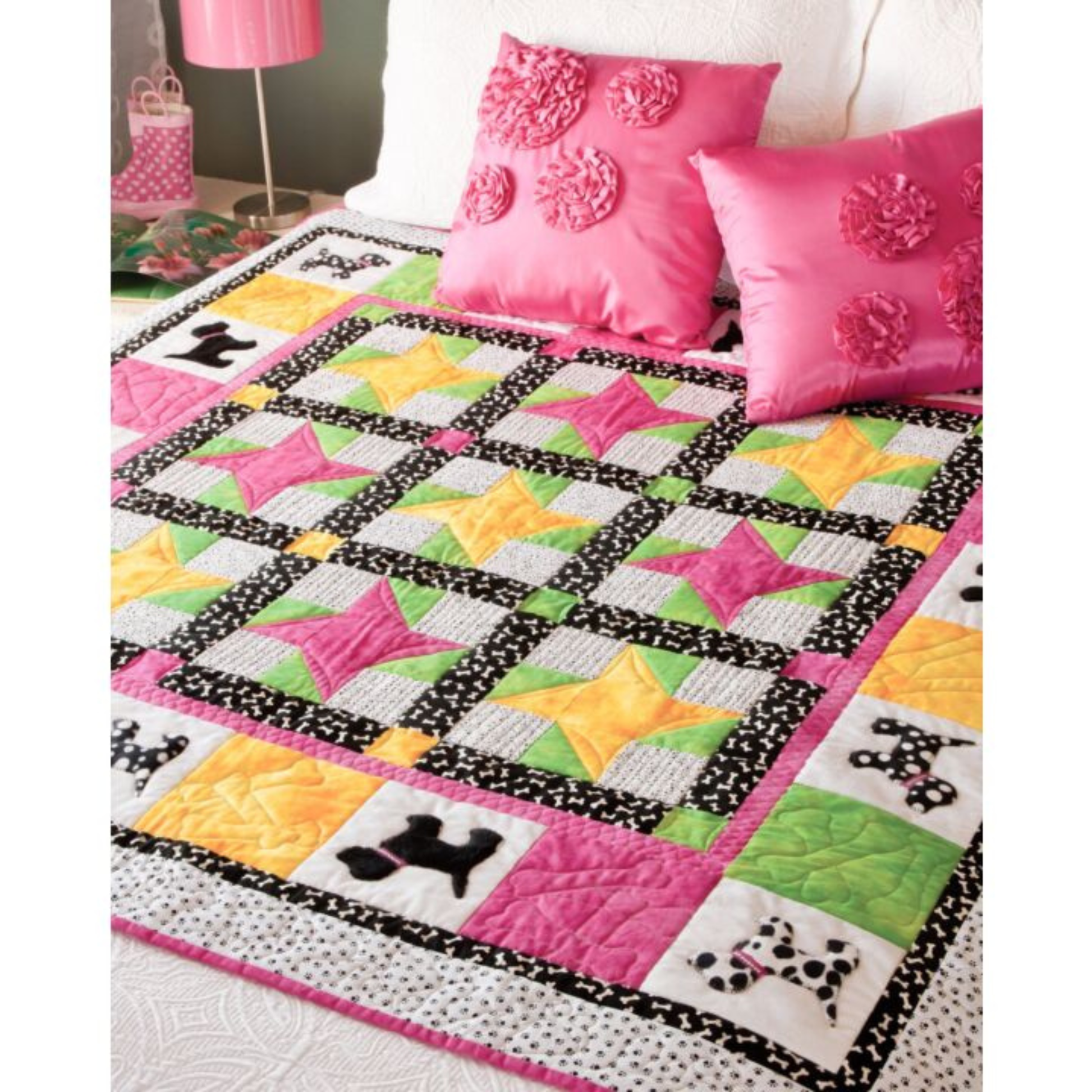 AccuQuilt GO! Gingham Dog quilt with pink star blocks and dog silhouette borders, styled with pink cushions