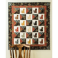 AccuQuilt GO! Calico Cat wall hanging with 20 cats in different fabrics, hung above an antique chair