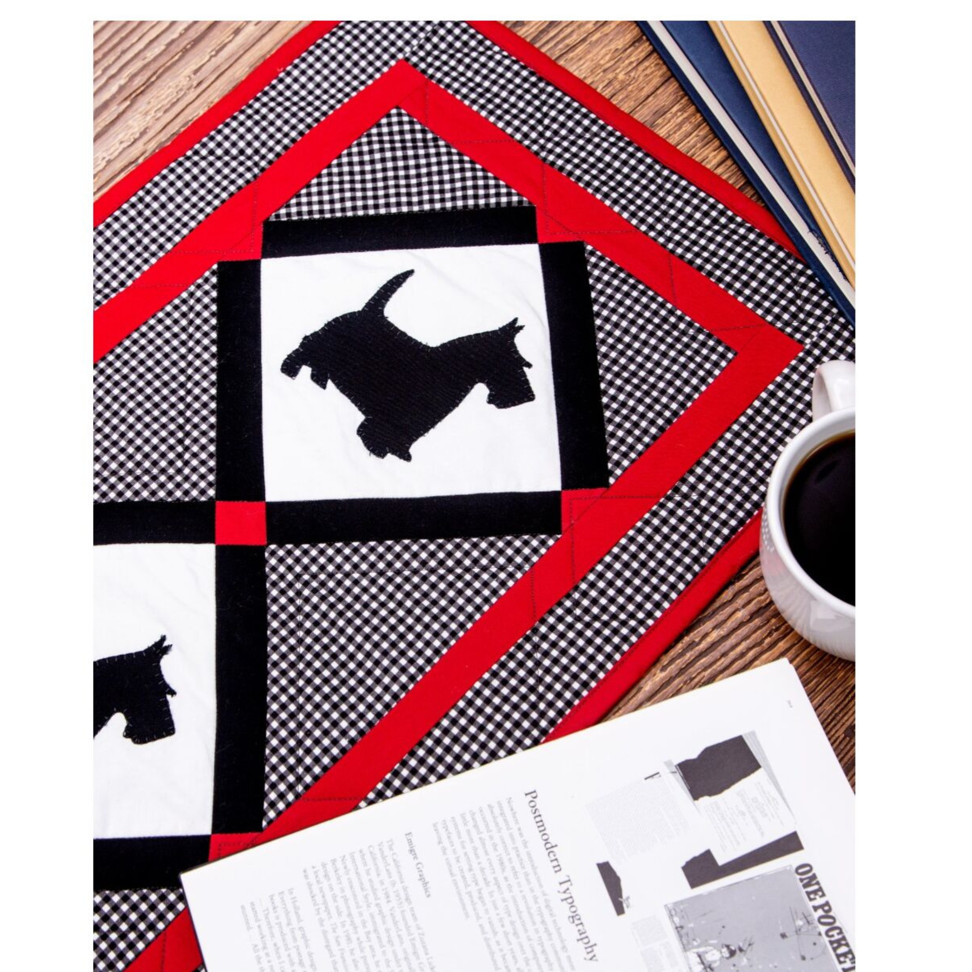 AccuQuilt GO! Scottie Dog table runner close-up styled with coffee and books