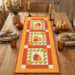 AccuQuilt GO! Pumpkins table runner styled on a table with candles, real pumpkins and place settings