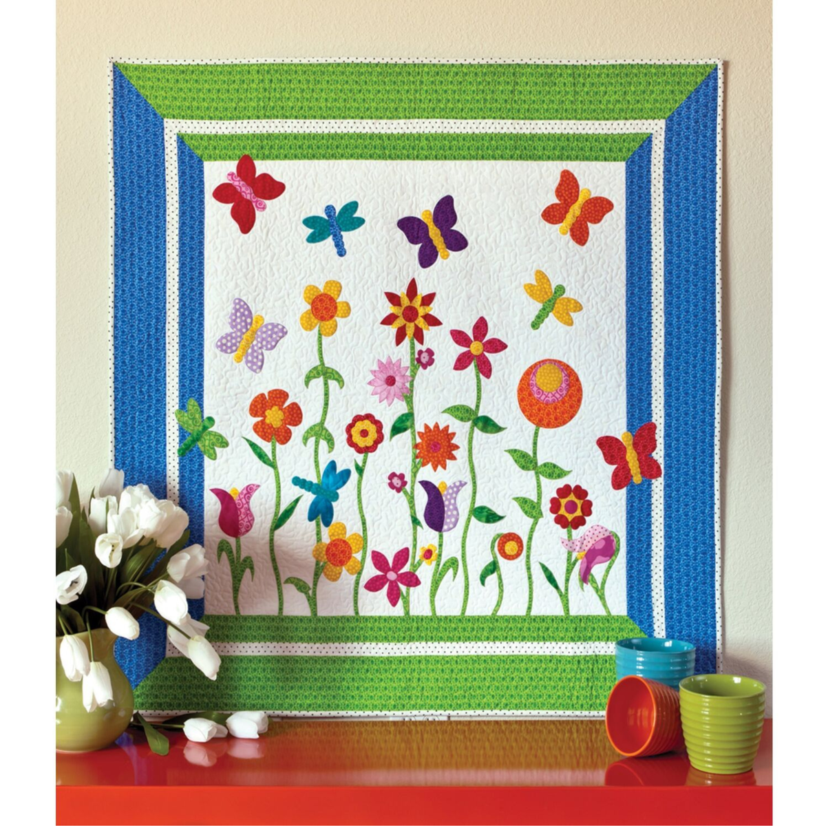 AccuQuilt GO! Stems & Leaves curved stems beneath a flower garden with butterflies and dragonflies