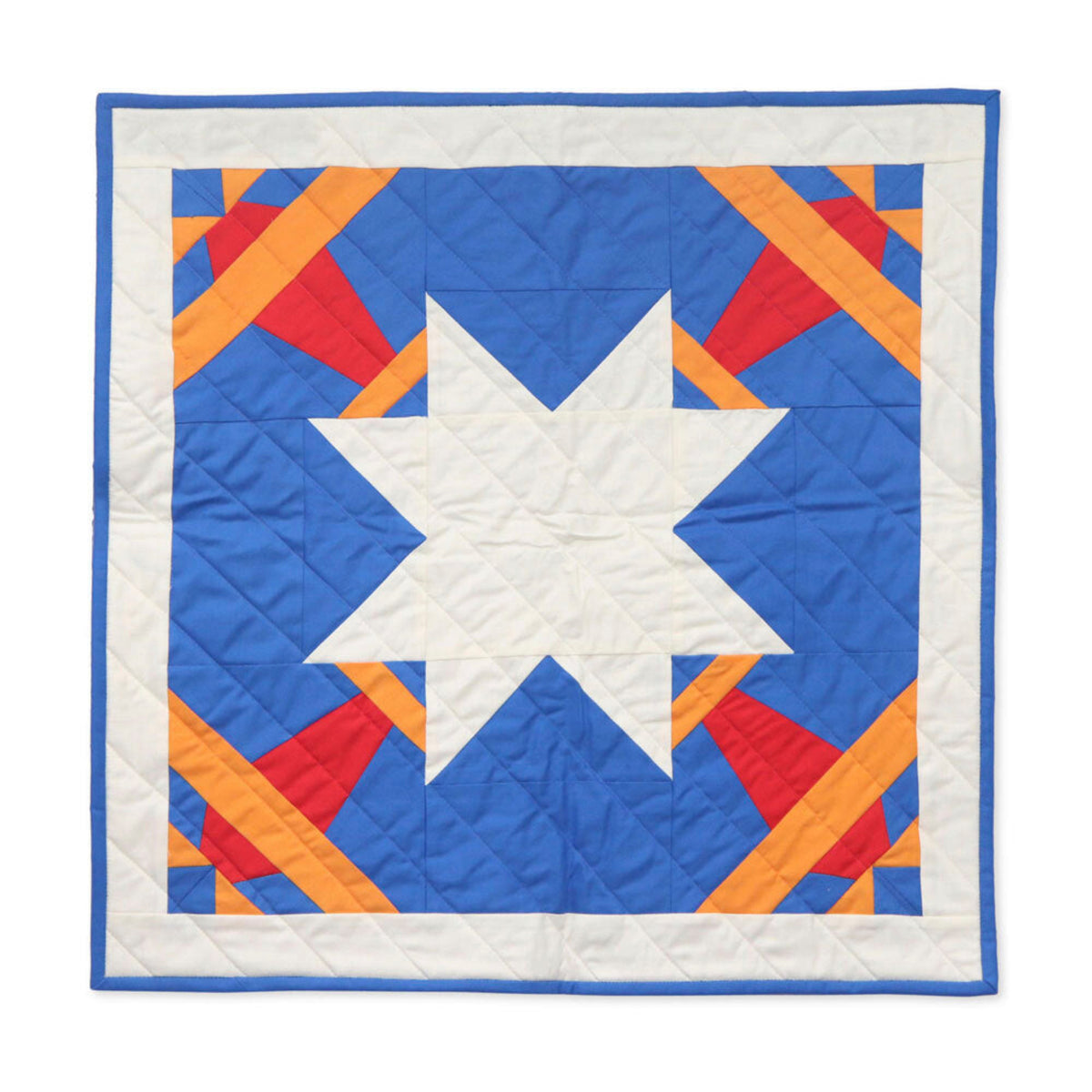 Square quilted wall hanging with a large white star, blue background and red and orange Airplane blocks