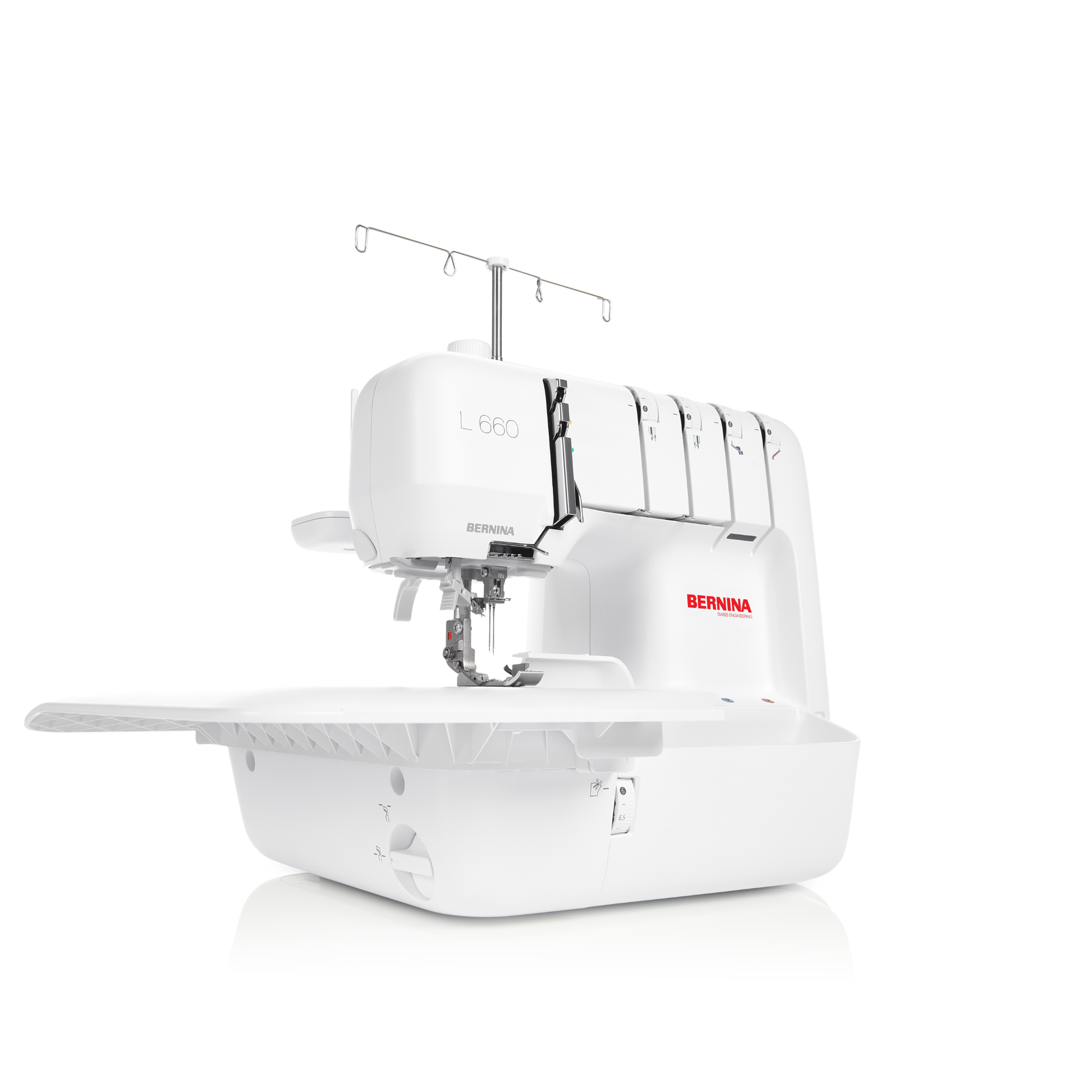 A white Bernina L-660 serger sewing machine with a white extended table, shown from a three-quarter angle on a clean white background.