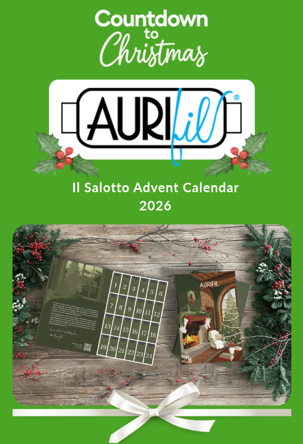 Countdown to Christmas with the Aurifil Il Salotto Advent Calendar 2026, featuring festive packaging and numbered doors, framed by holly and a white ribbon.