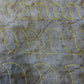 Separate rope quilting motifs in different sizes stitched in yellow thread on grey patterned fabric