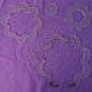 Daisy sample on purple fabric