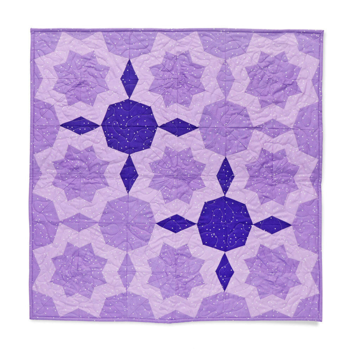 Completed quilt wall hanging made using the AccuQuilt GO! Double Star Block on Board die, featuring a repeating double star pattern in tonal lavender and deep purple dotted fabrics with decorative quilting