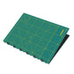 Folded Green cutting mat with grid lines and measurements on a white background