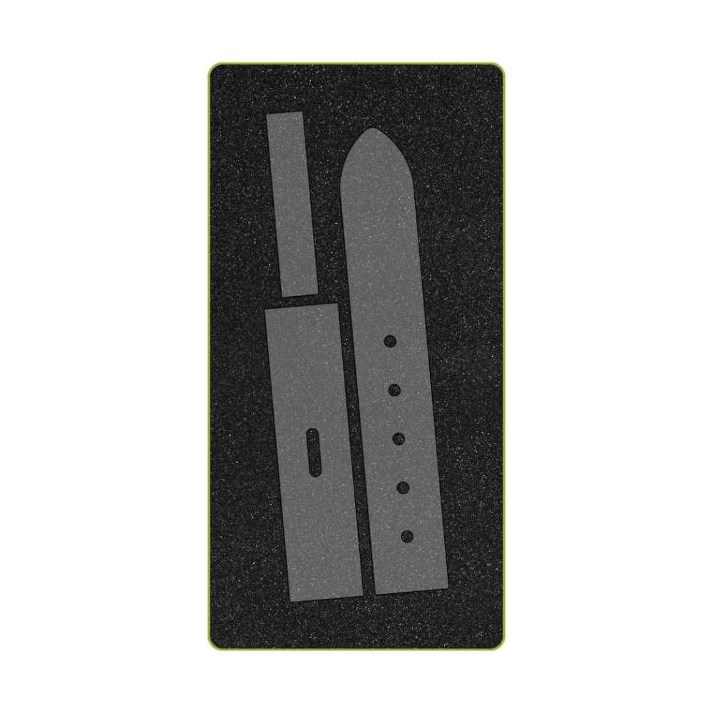 AccuQuilt GO! Belt 1½" Fabric Cutting Die set showing three die shapes on foam mat — pointed belt end, belt keeper loop, and belt body with buckle slot and five punch holes