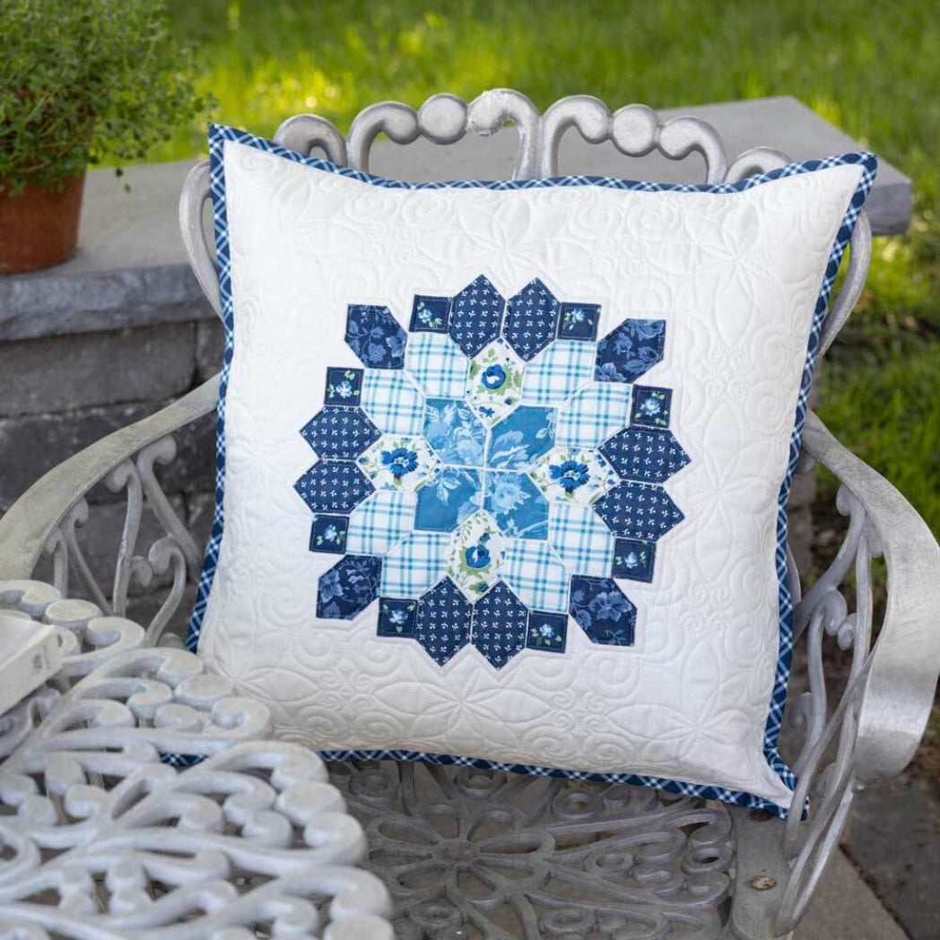 White quilted cushion cover with navy blue honeycomb EPP star medallion design and gingham border made with AccuQuilt GO! Honeycomb die