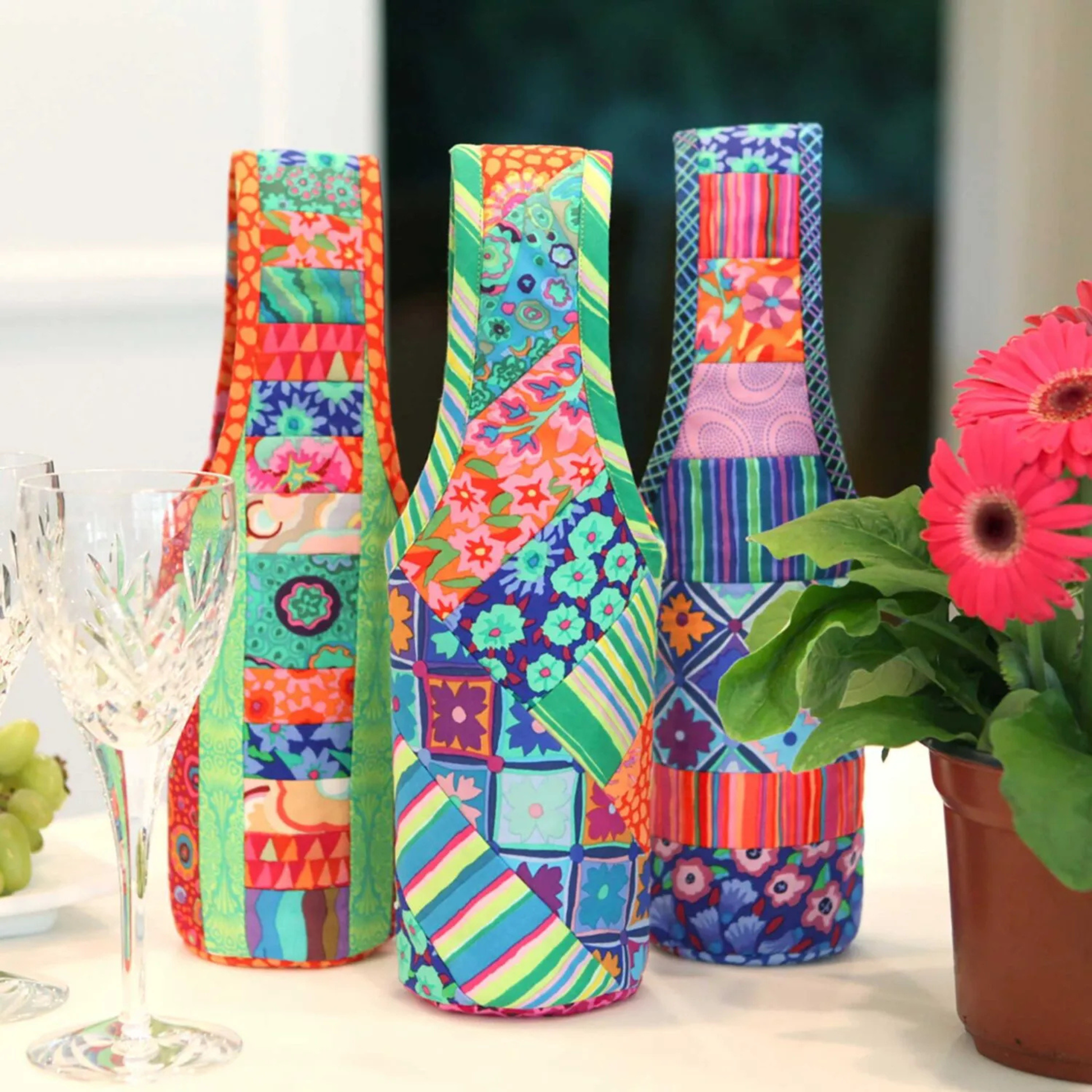 Three completed quilted wine totes made using the June Tailor Quilt-As-You-Go kit