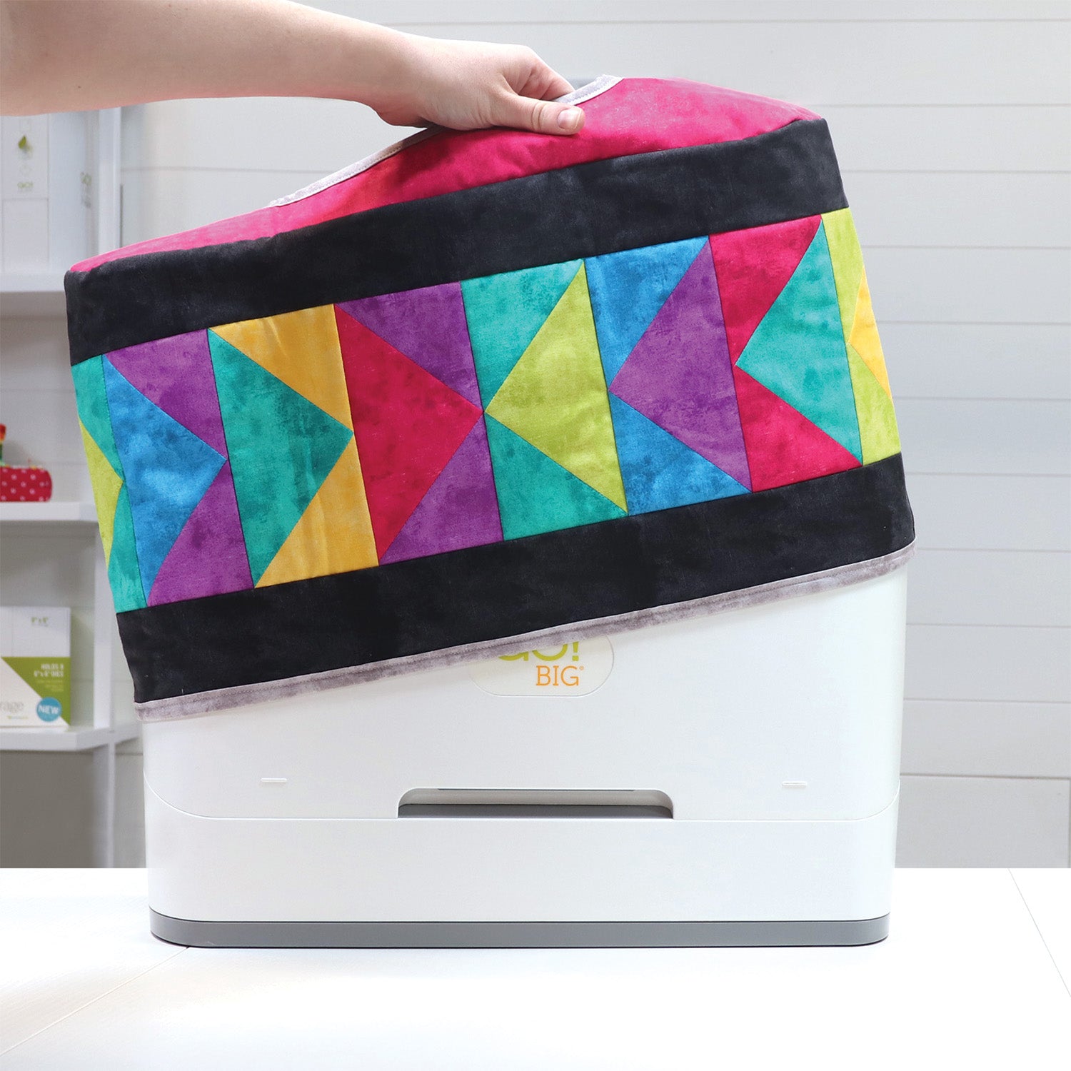 Hands sewing the June Tailor AccuQuilt GO! Big Cutter Cover Quilt-As-You-Go kit
