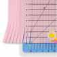 June Tailor 12x12 Shape Cut gridded quilting ruler with rotary cutter cutting slots showing fringing technique