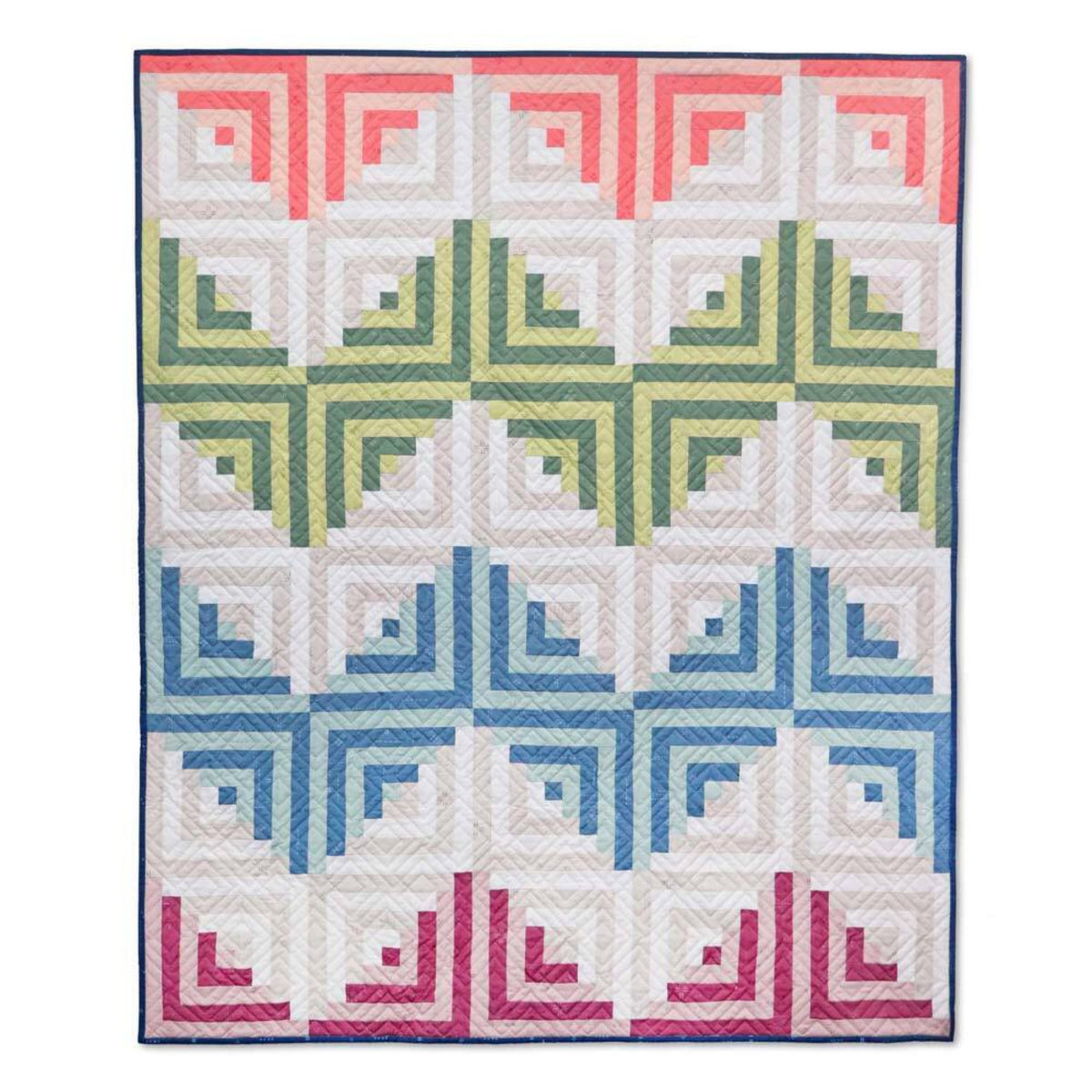 Baby quilt made from Log Cabin blocks, with rows of coral, green, blue and pink designs against a white background.