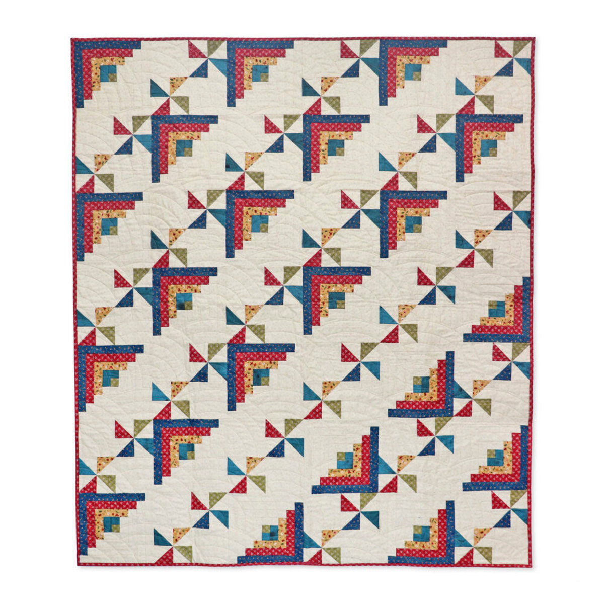 Patchwork throw quilt with red, blue and gold Log Cabin corners and multicoloured pinwheel motifs on a cream background.