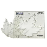 Clear plastic square shaped quilting template with a leaf shaped cut out. It  has clear registration marks that are easy to see, and a non slip backing that provides a fabric gripping action.