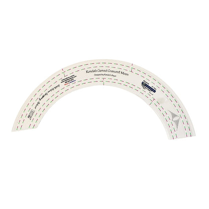 Clear plastic crescent moon shaped quilting template with registration marks that are easy to see. There are ¼ inch and ½ inch markings. A non slip backing gives it a fabric gripping action.