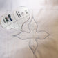 Mini Heart Gripping Action template beside a four-point quilting motif on white fabric
