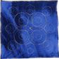 Gold-stitched quilting on blue fabric forming a symmetrical arrangement of large and small spirals