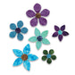 Six fabric flowers made with AccuQuilt GO! Garden Variety #2 shapes, showing purple, blue and green petals in three sizes with contrasting circular centres.