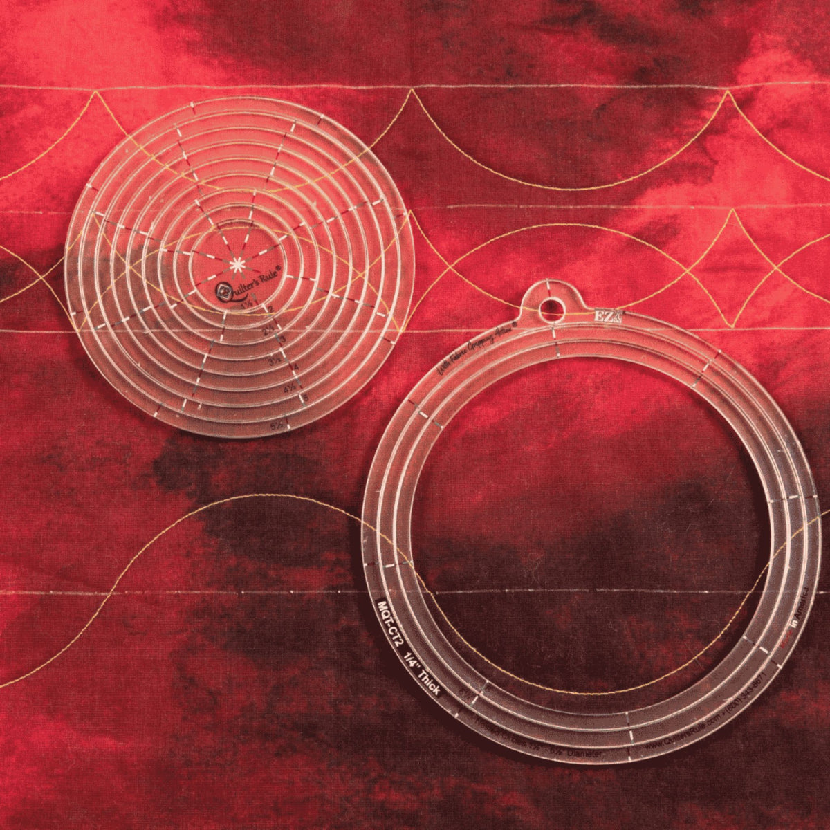 Nested Circles acrylic templates positioned over curved quilting border designs on red fabric