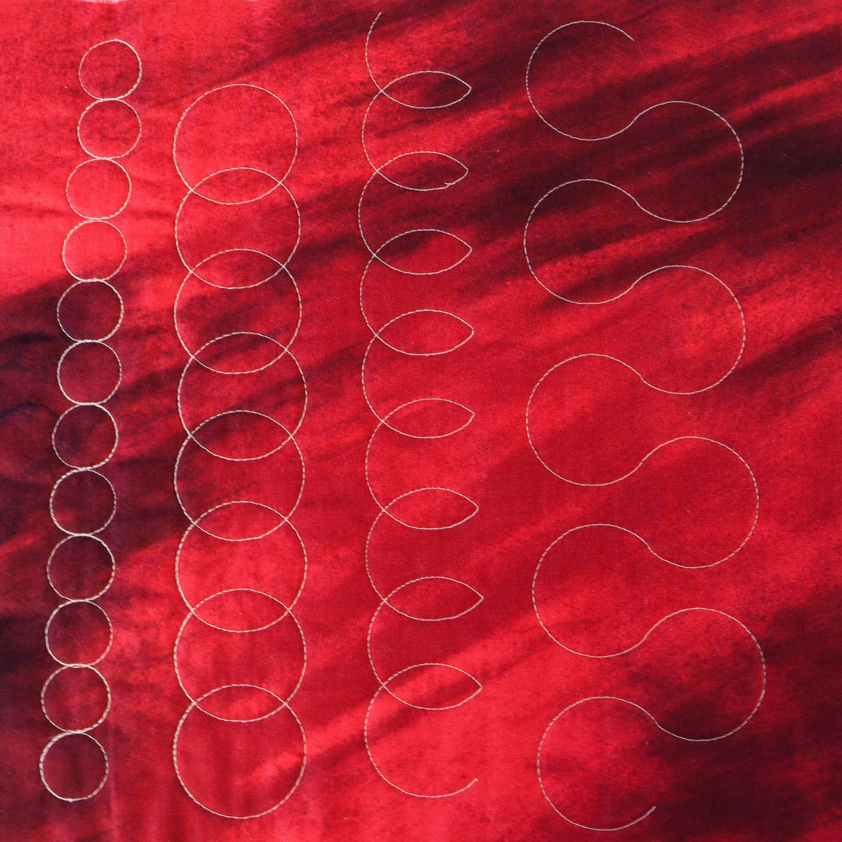 Nested mini circles sample on red fabric
