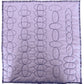 Rows of alternating and overlapping oval quilting borders stitched in dark thread on pale fabric