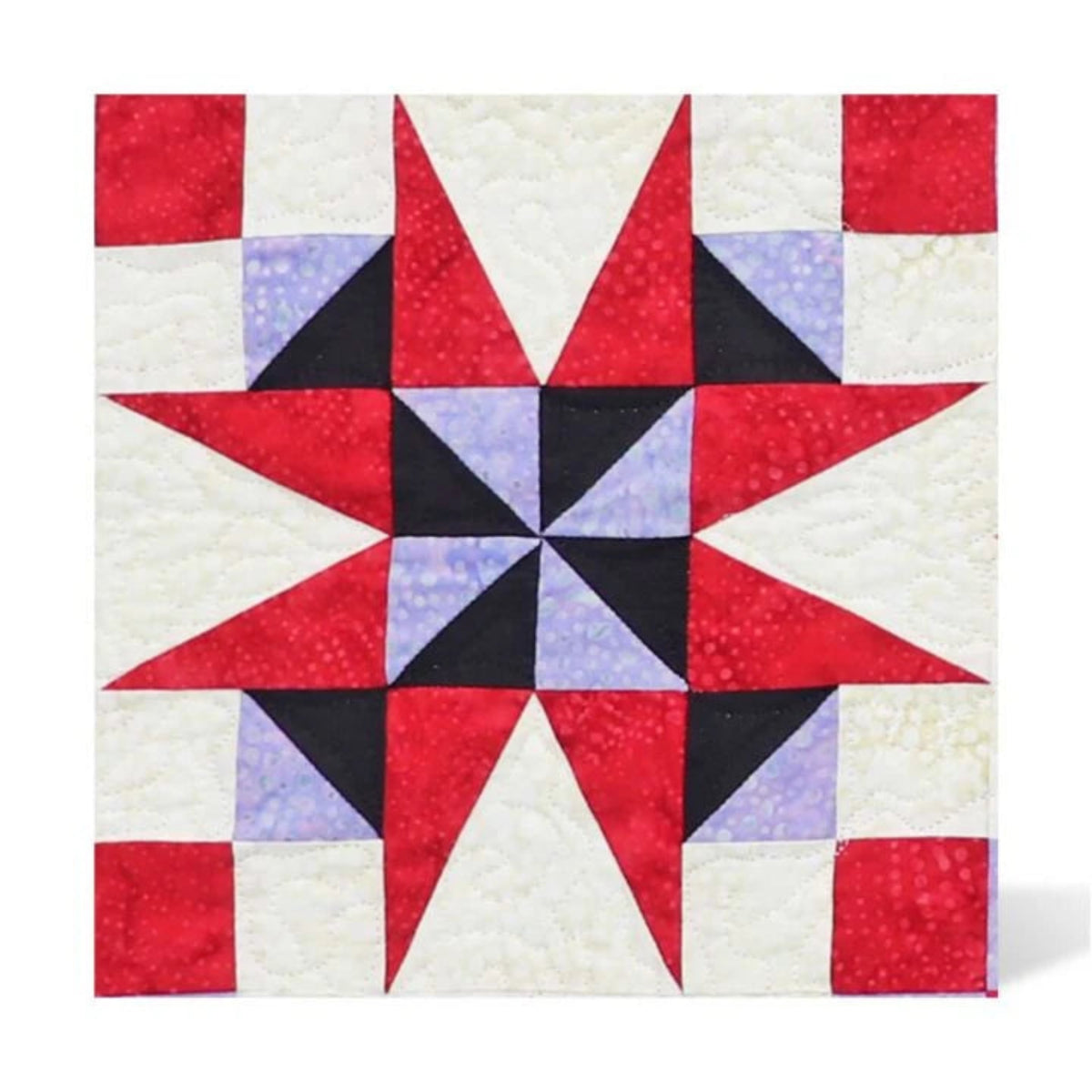 AccuQuilt GO! Nine Patch Shape Set sample quilt block with a black and lilac pinwheel centre, red star points and red corner squares on a cream background.