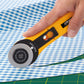 Hand holding a yellow rotary cutter on a blue and white checkered fabric background