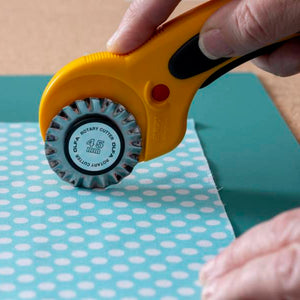 Genuine Olfa 45mm Pinking Blade creating a pinked edge on fabric