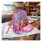 Colorful polka dot backpack with stationery items on a wooden table, byannie.com branding visible.