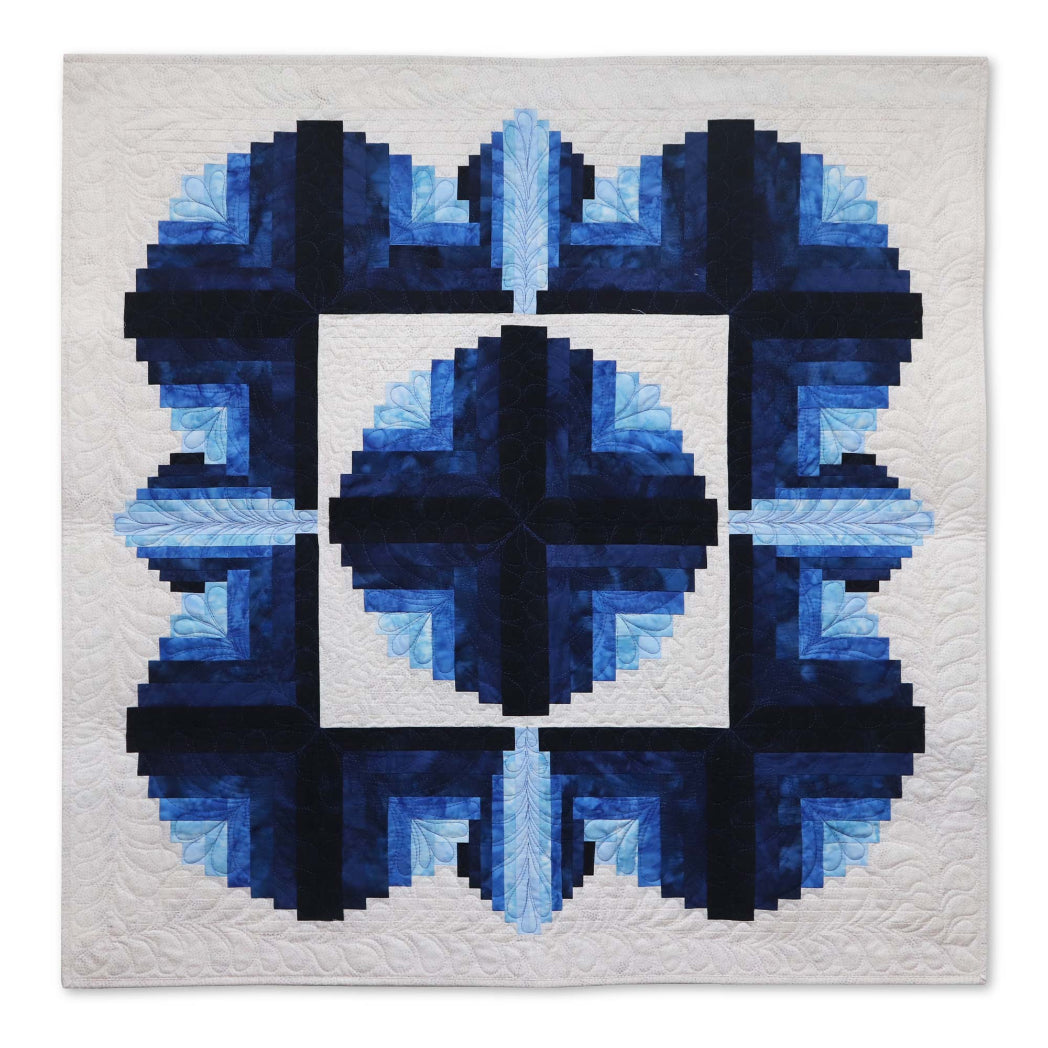AccuQuilt GO! Curved Log Cabin 9" Block On Board Die - finished navy and cream quilt showing four blocks arranged to create a circular medallion design