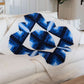AccuQuilt GO! Curved Log Cabin 9" Block On Board Die - finished navy blue and cream quilt draped over a sofa showing the curved log cabin block design