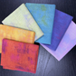 Set of colourful fabric pieces on a dark surface