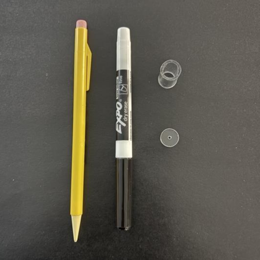 Yellow pen and Expo marker on a dark gray background