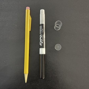 Yellow pen and Expo marker on a dark gray background