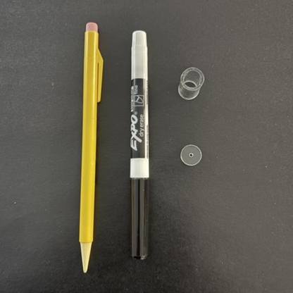 Yellow pen and Expo marker on a dark gray background