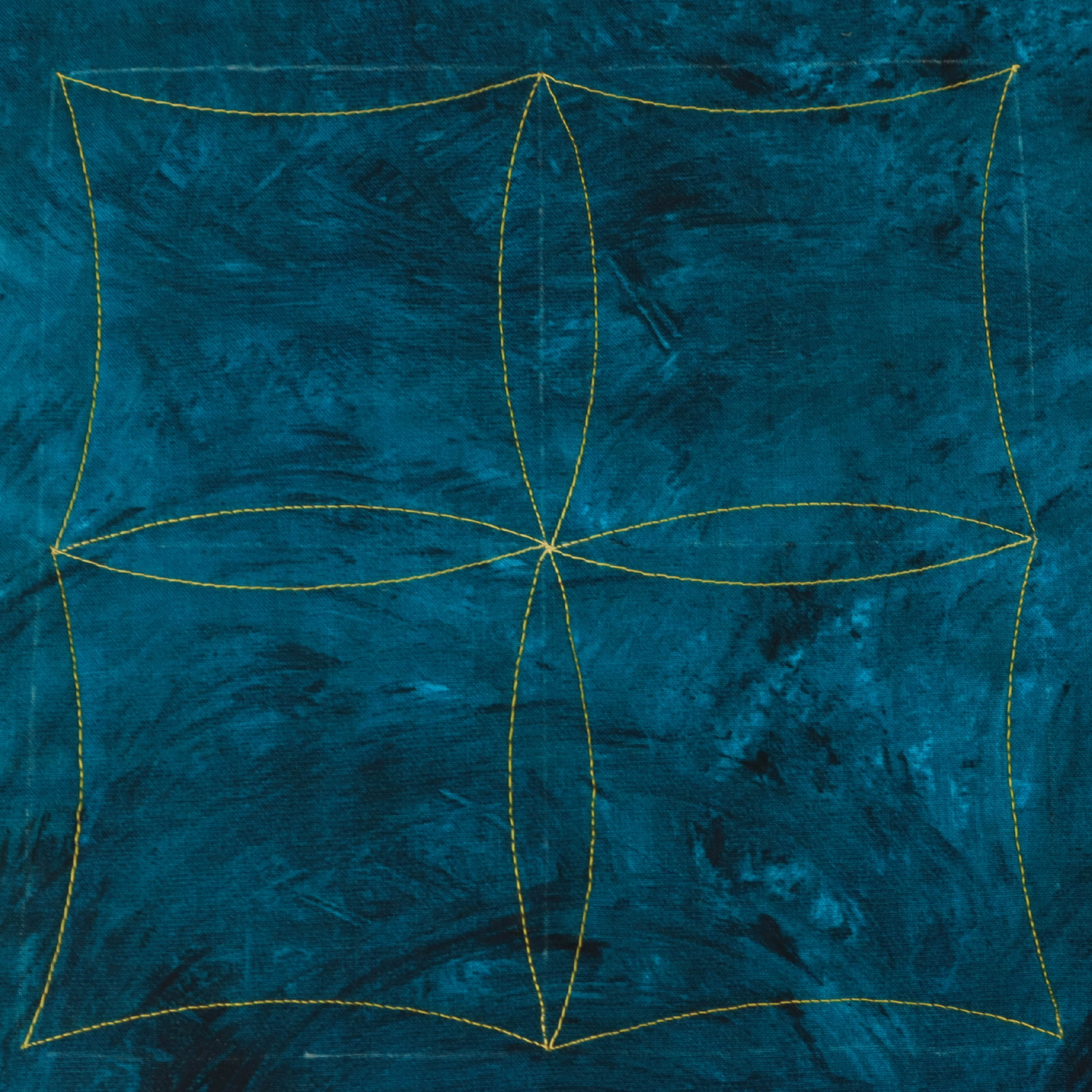 Teal fabric with gold embroidery on a white background