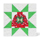 Completed AccuQuilt GO! Ugly Sweater 8" quilt block in red snowflake and green polka dot fabrics, set within a pieced star border on a white quilted background
