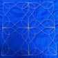 Swirl sample on blue fabric with gold thread
