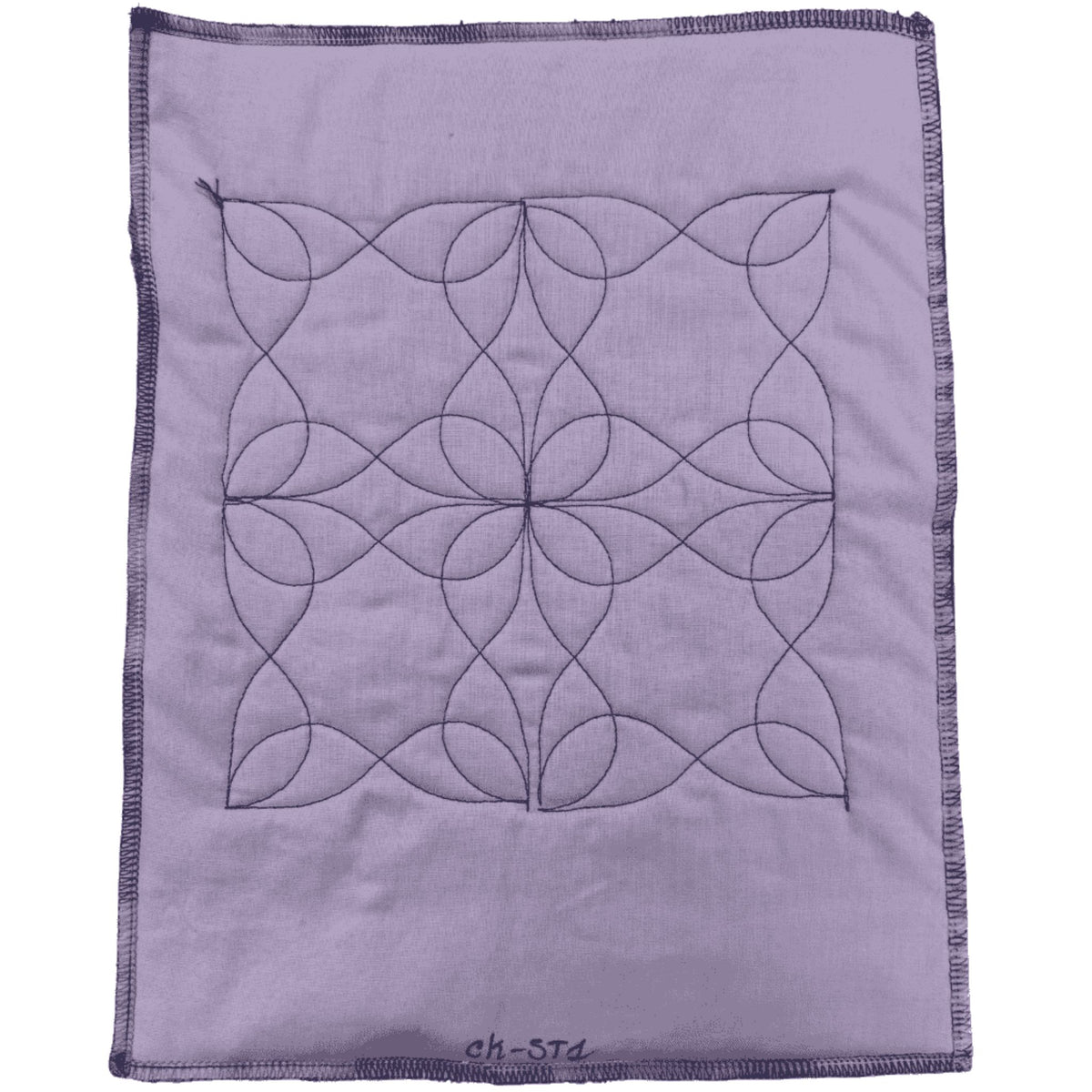 Swirl sample on purple fabric with black thread